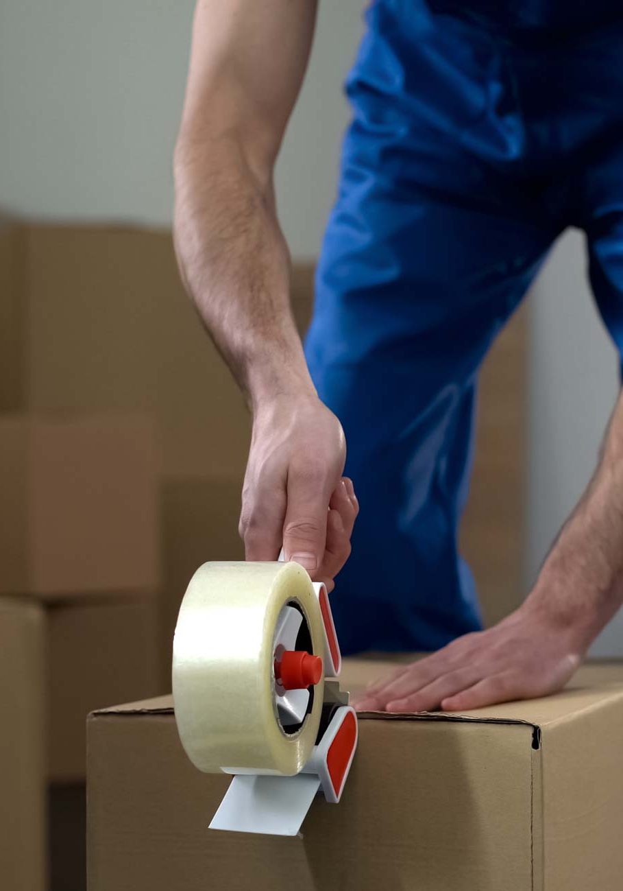 Moving company worker packing cardboard boxes, quality delivery services Belfast | County Down | County Antrim